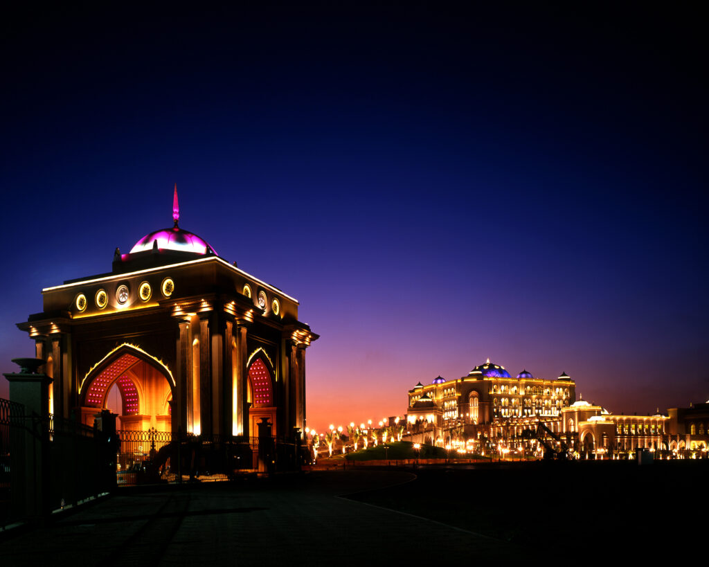 Emirates Palace illuminated at dusk in Abu Dhabi