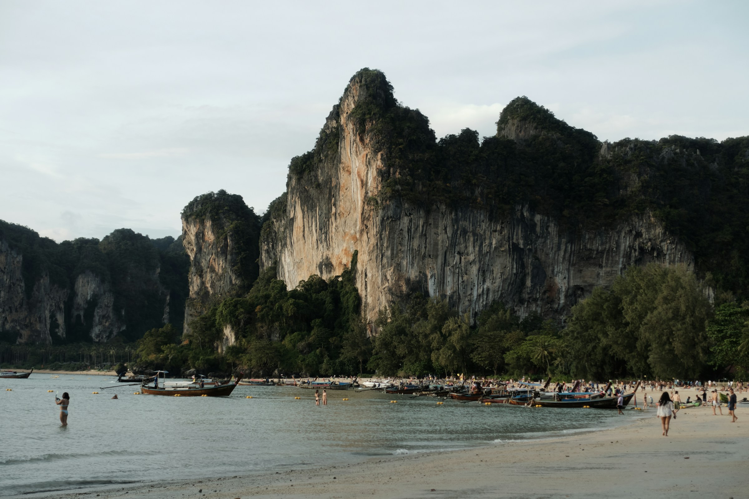 Beach with limestone cliffs and longtail boats, Krabi