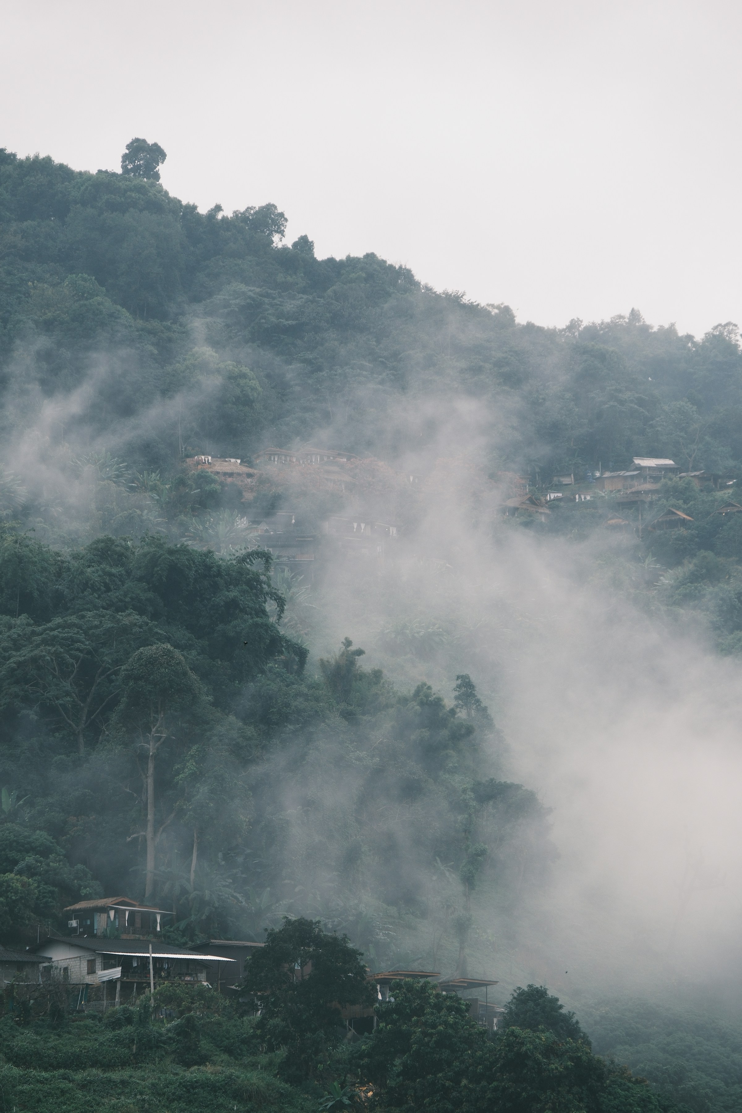 Foggy mountain with houses, northern Thailand