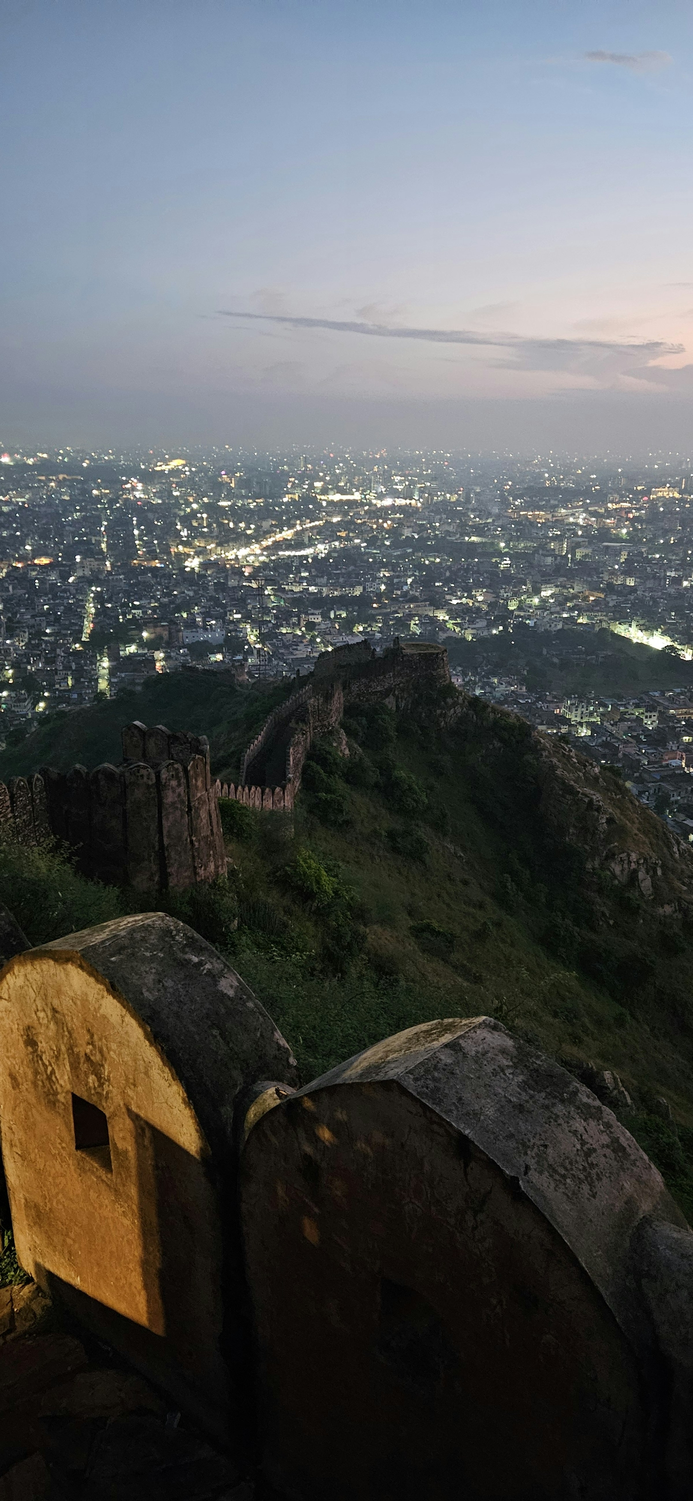Ancient fort wall overlooking a city at dusk, Amber Fort