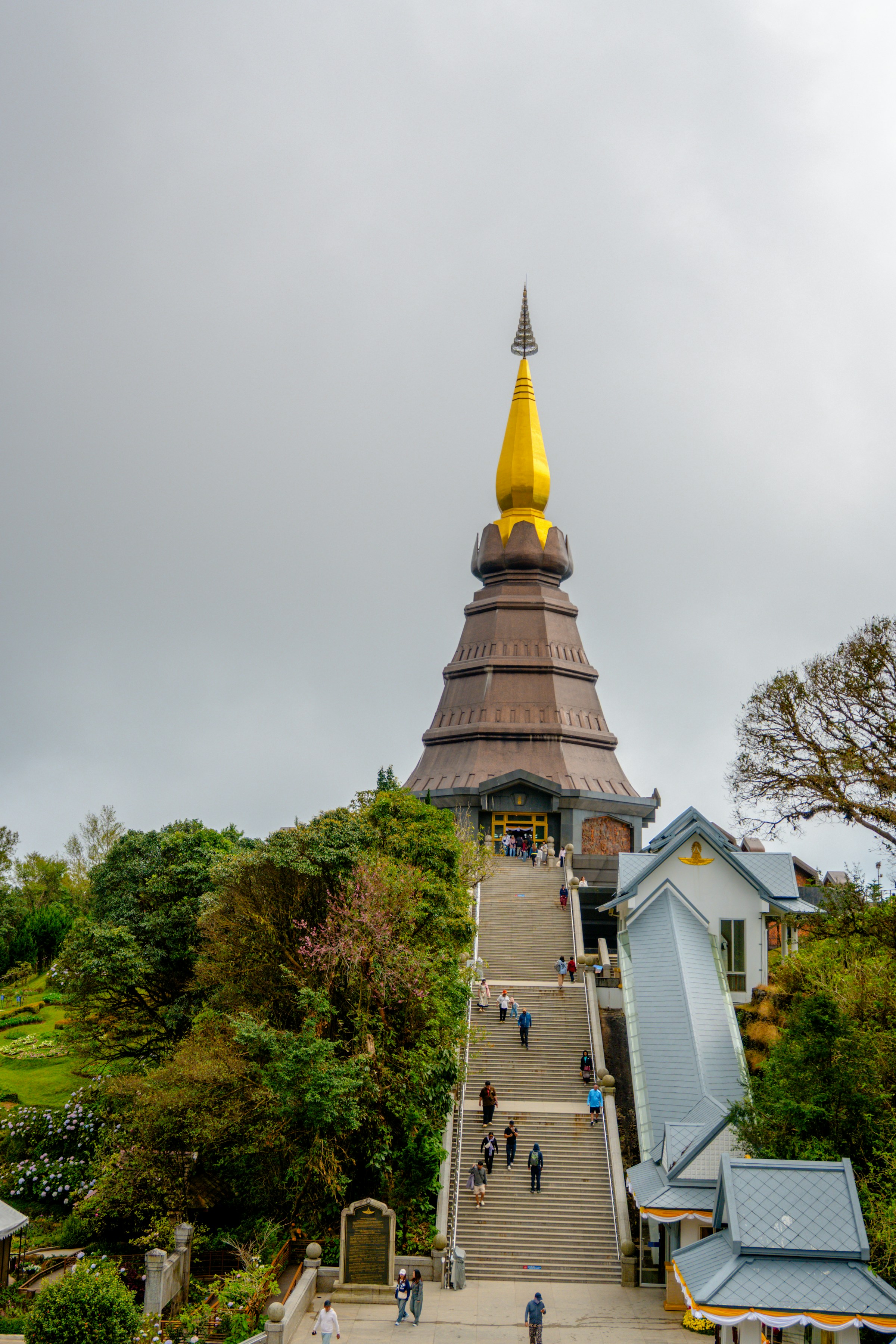 Grand golden pagoda atop a hill with a long staircase