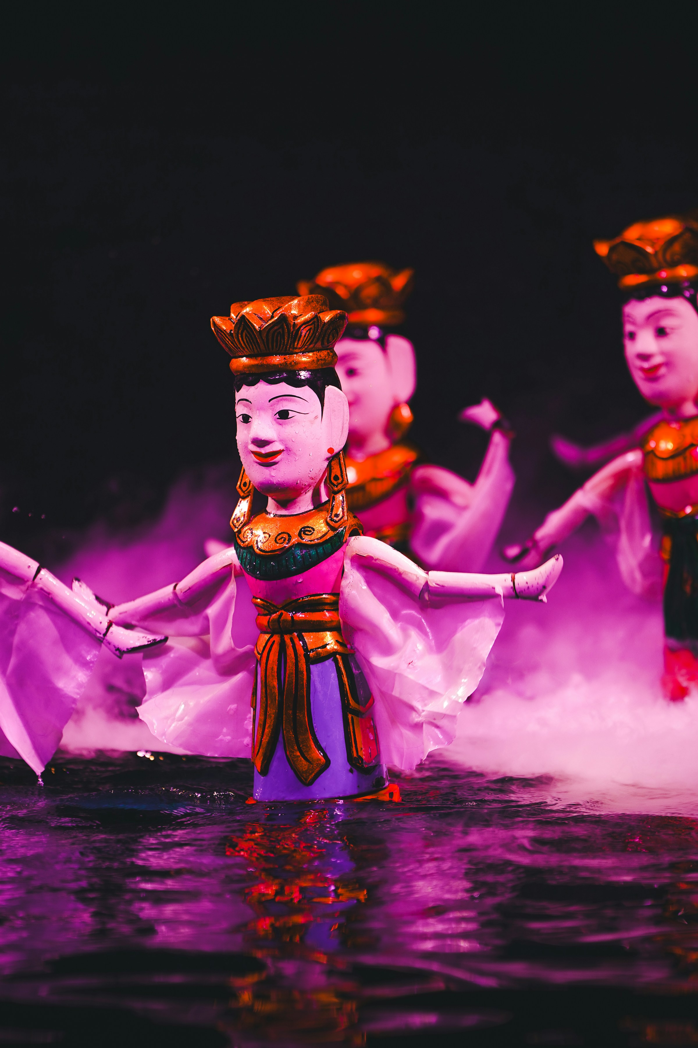 Water puppets performing on a stage