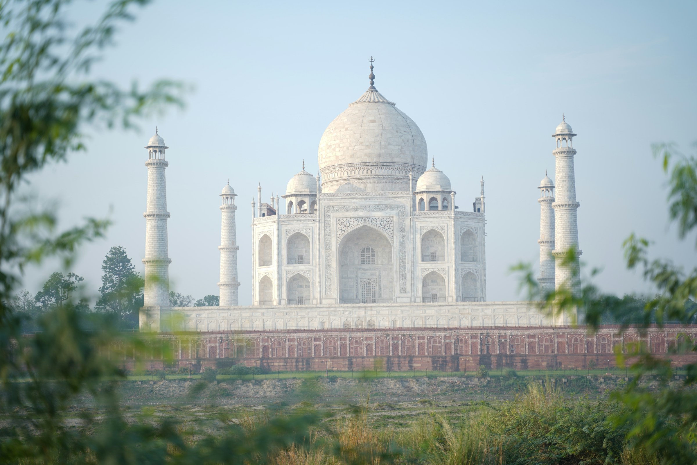 Large white building with towers, Taj Mahal in the background, Mehtab Bagh