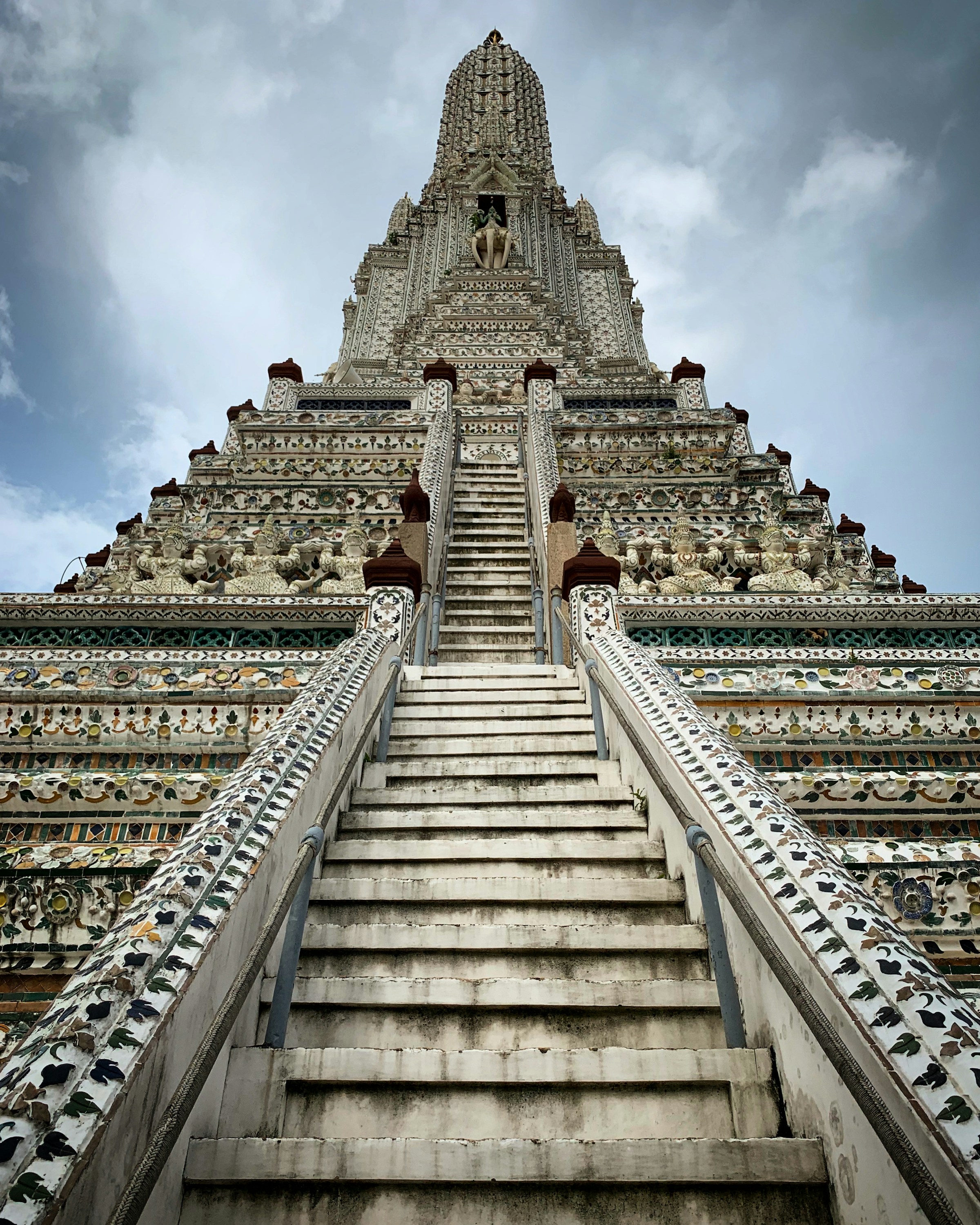 Grand ornate temple stairs leading to a pagoda