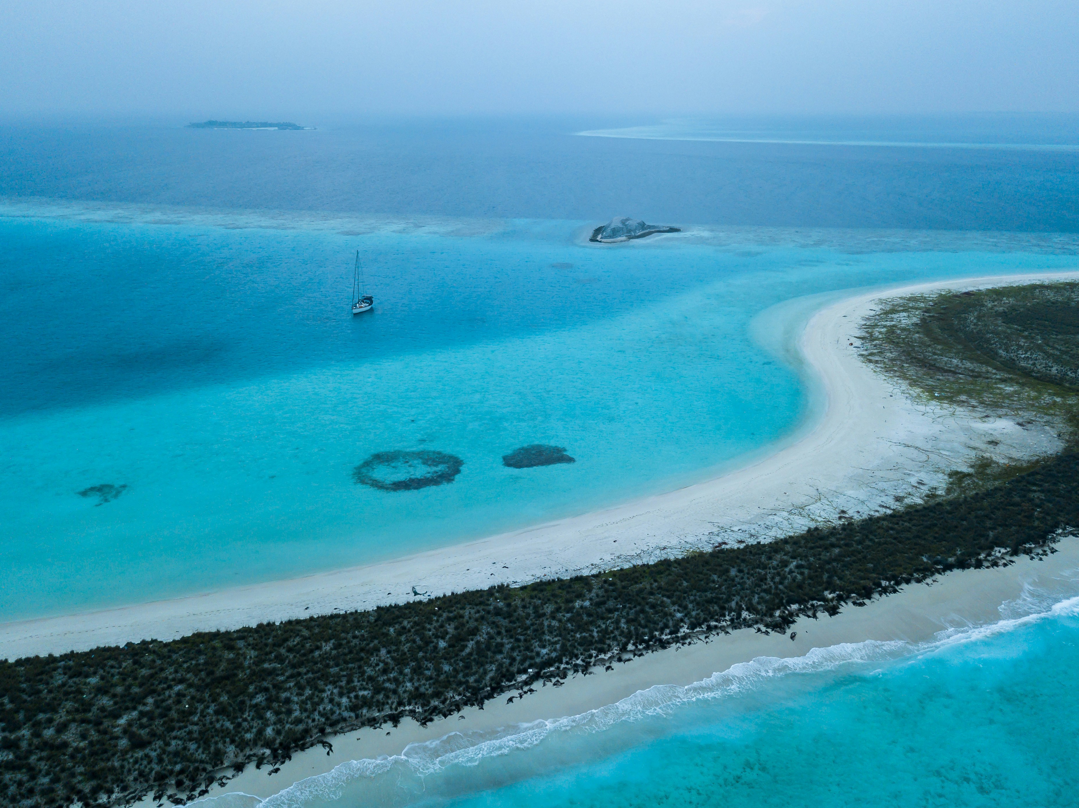 Turquoise ocean and dark rocky island
