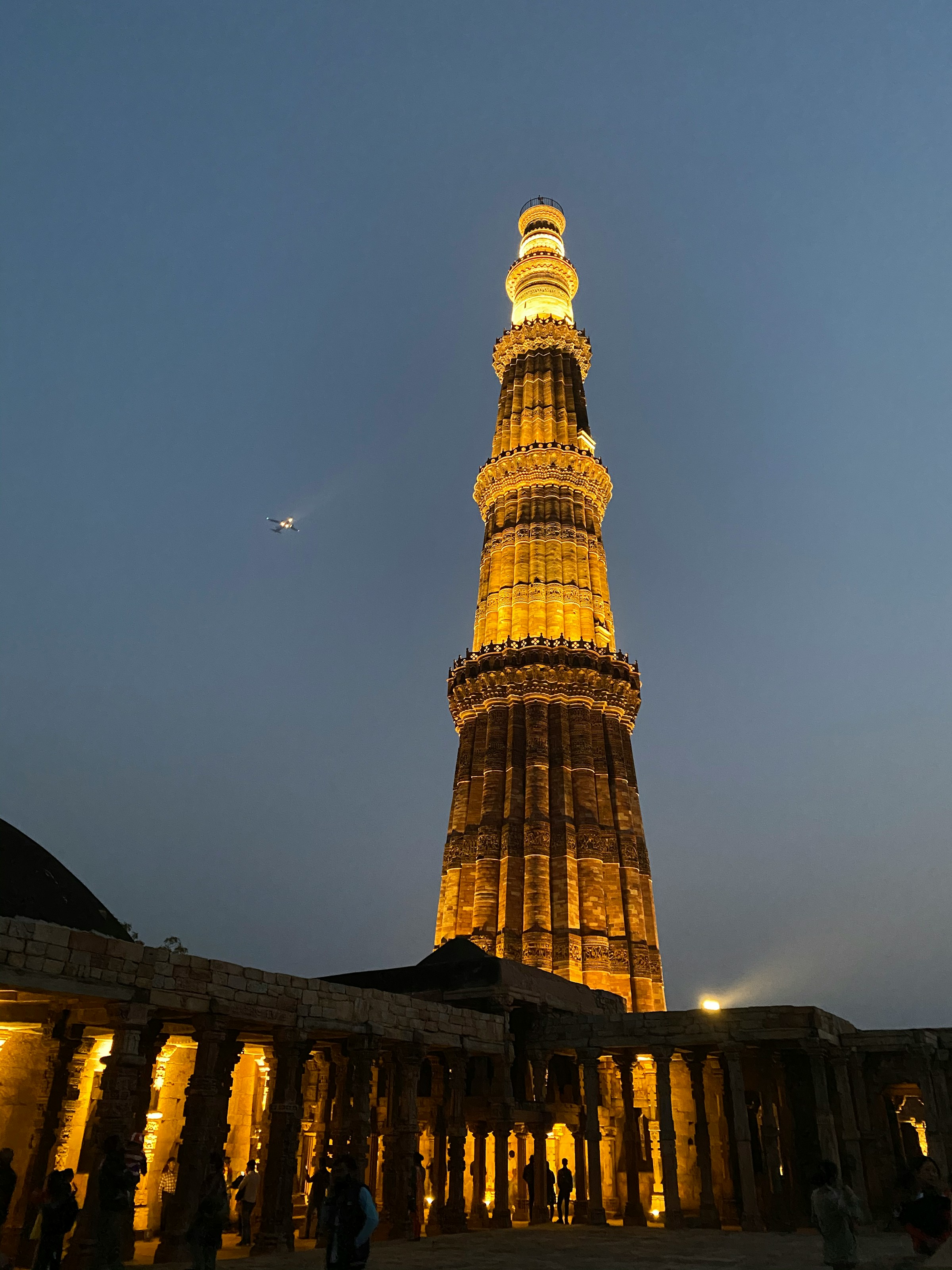 Brown and white tower against a blue sky, Qutub Minar
