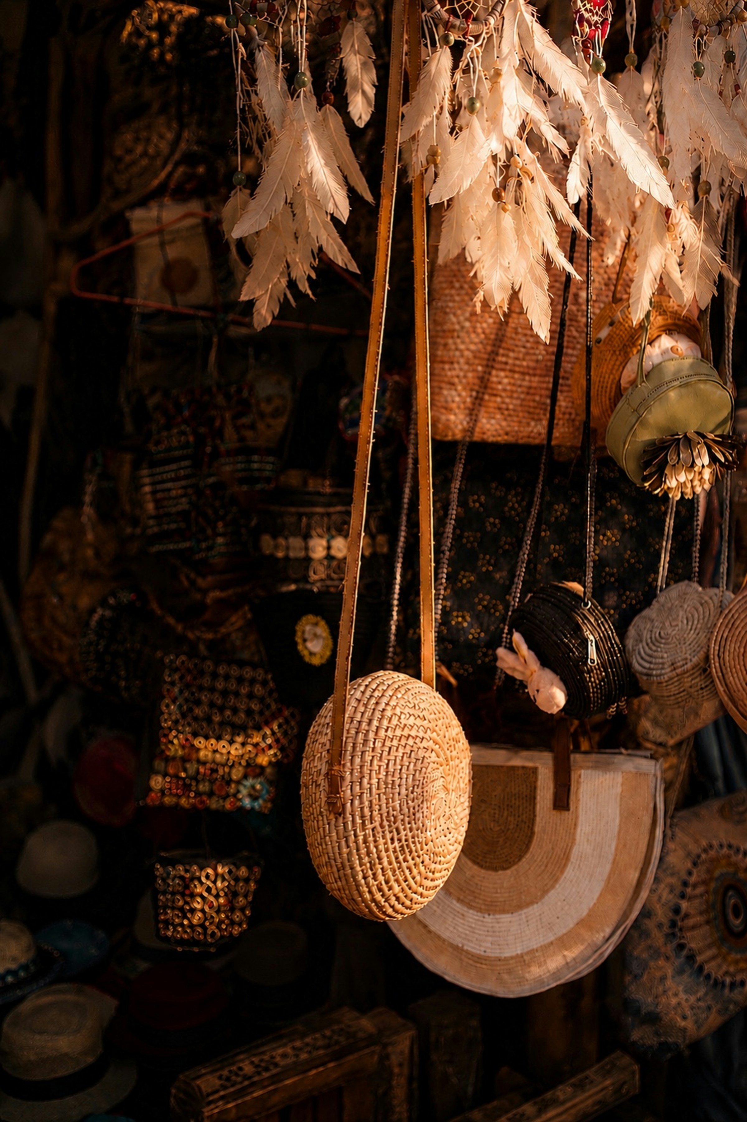 Round woven straw bag hanging in a market stall