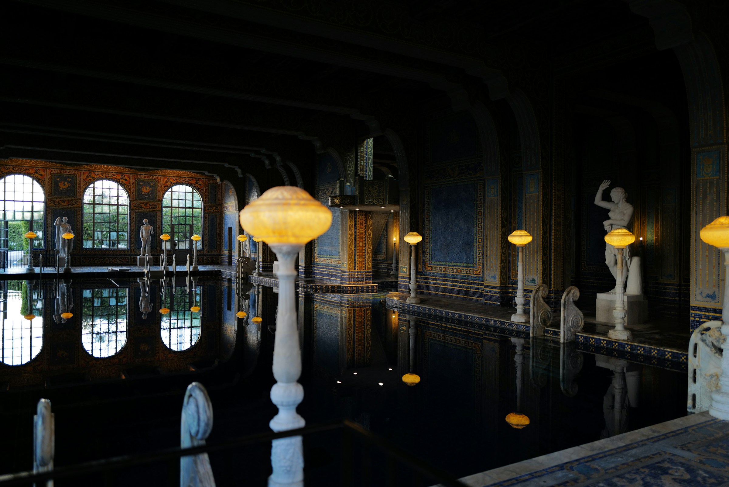 Indoor swimming pool with ornate decorations and statues