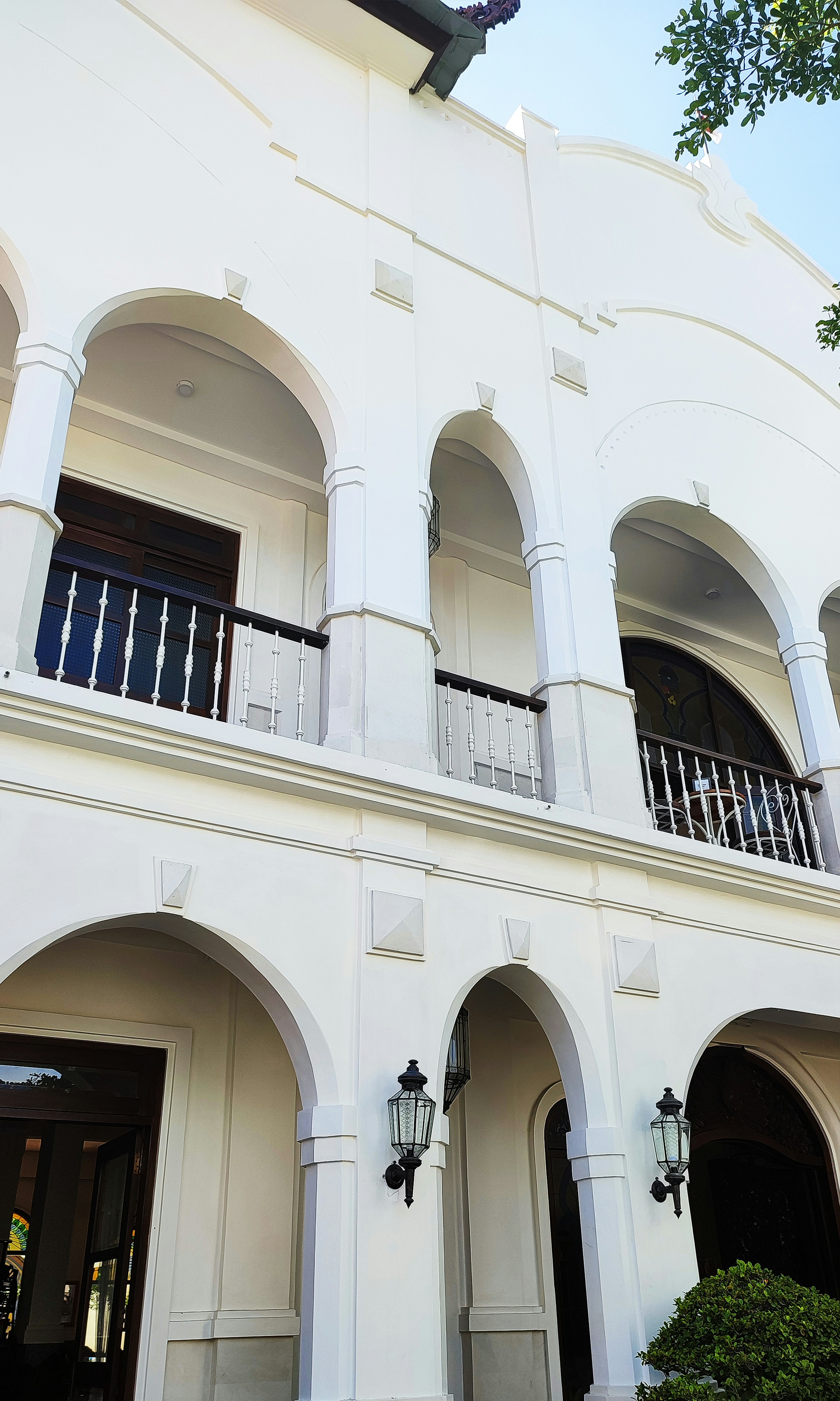 Large white building with arches and balconies