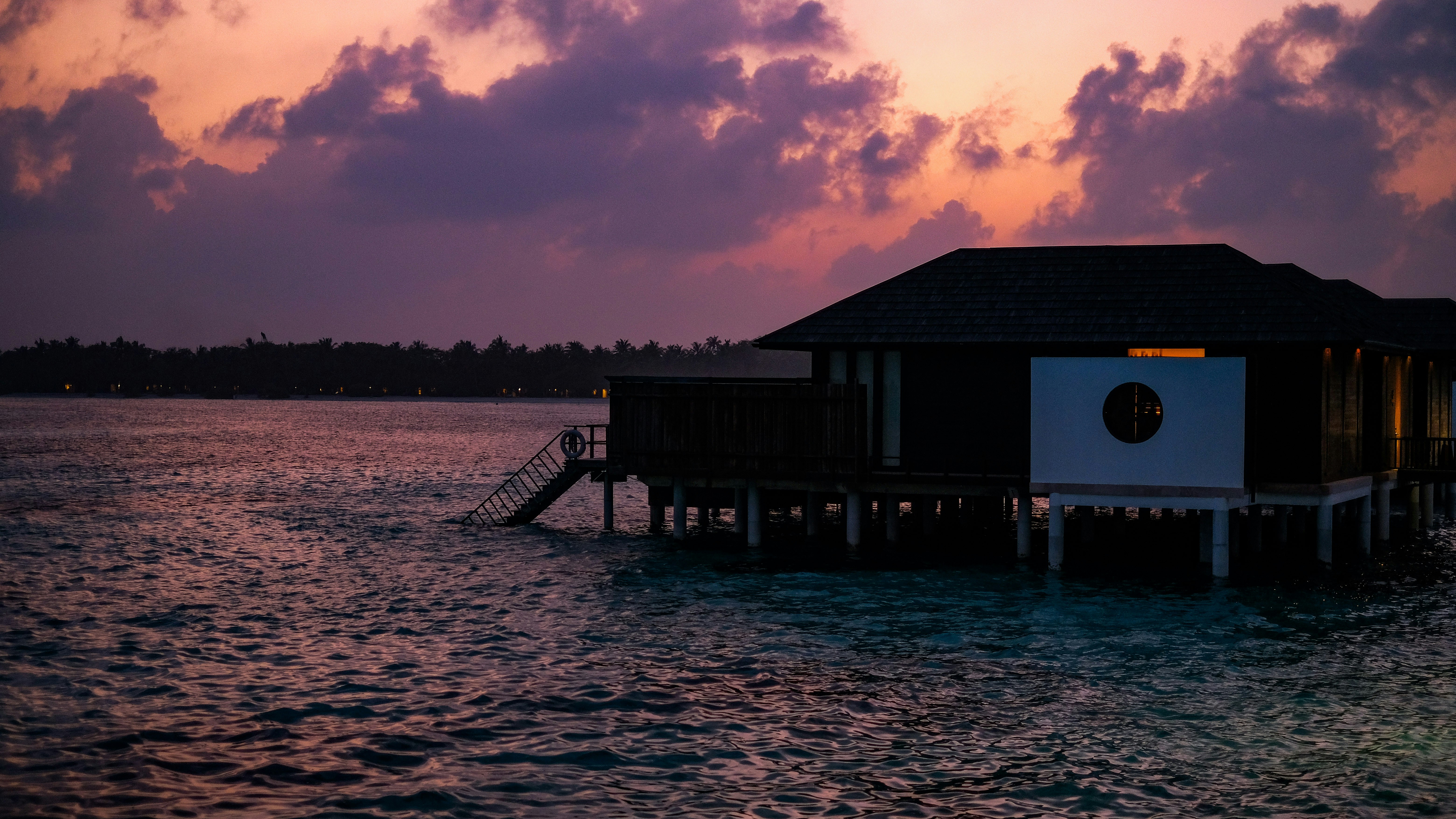 Luxury overwater bungalow at sunset