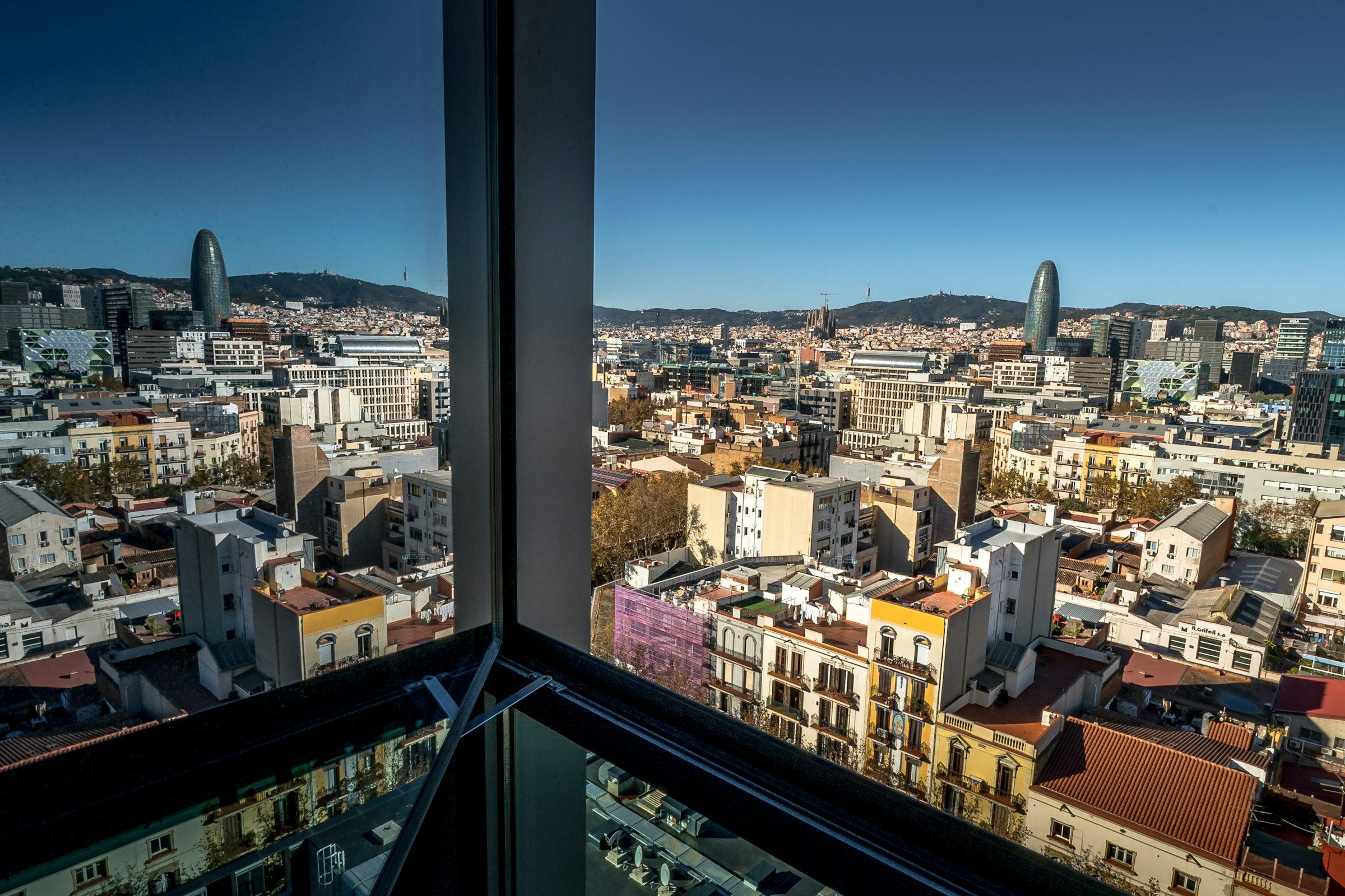 City skyline with modern buildings and mountains