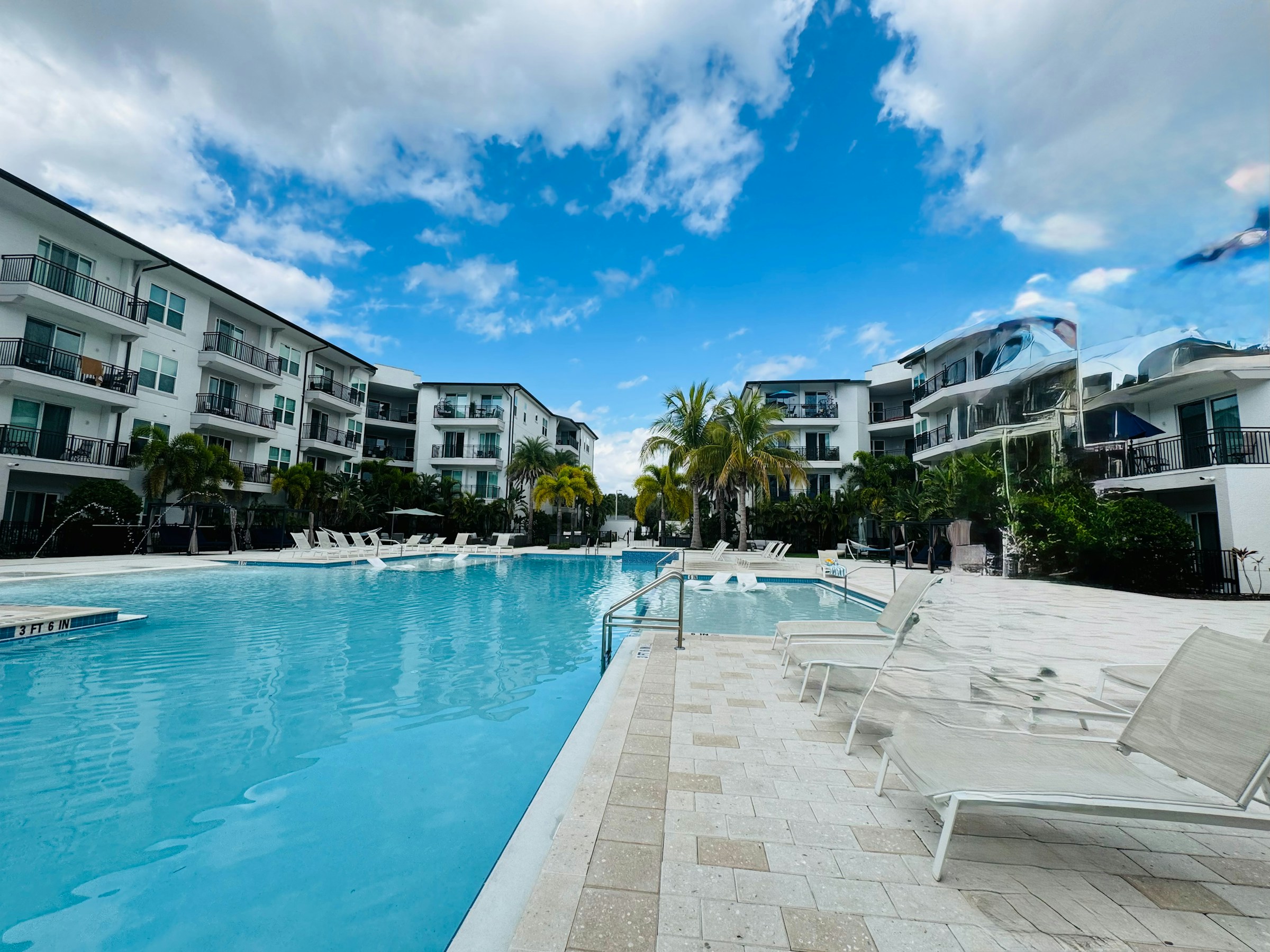 Modern resort with a large swimming pool and lounge chairs