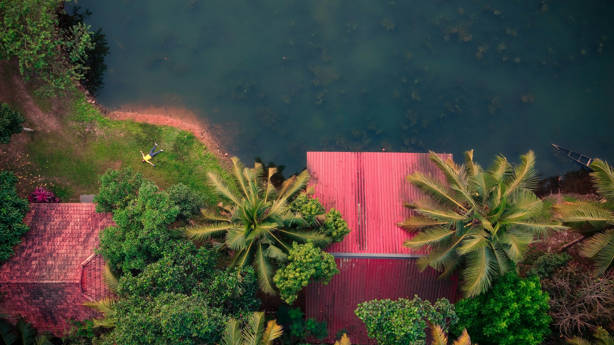 Red heritage building surrounded by trees, Kottayam backwaters