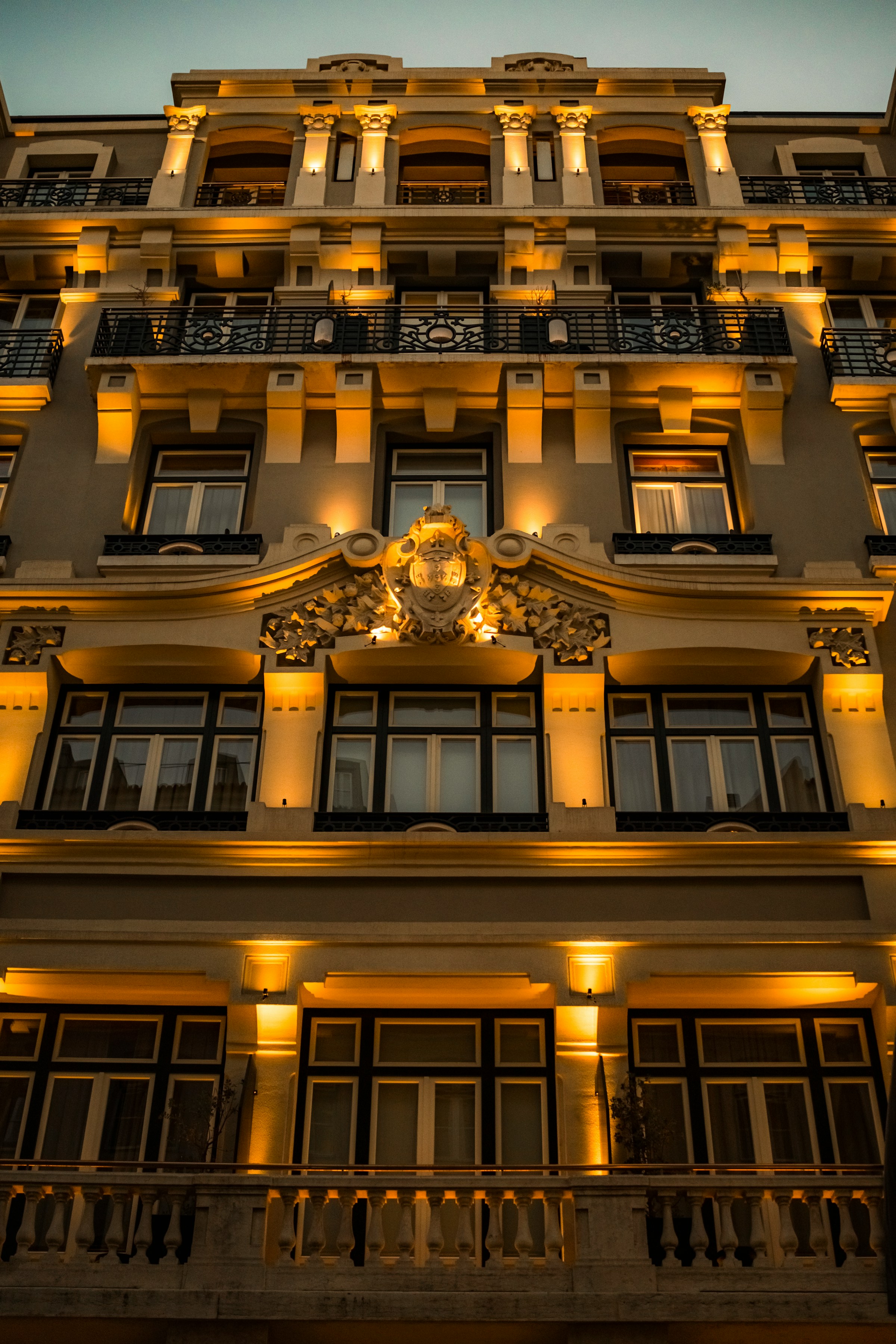 Ornate building facade illuminated at dusk