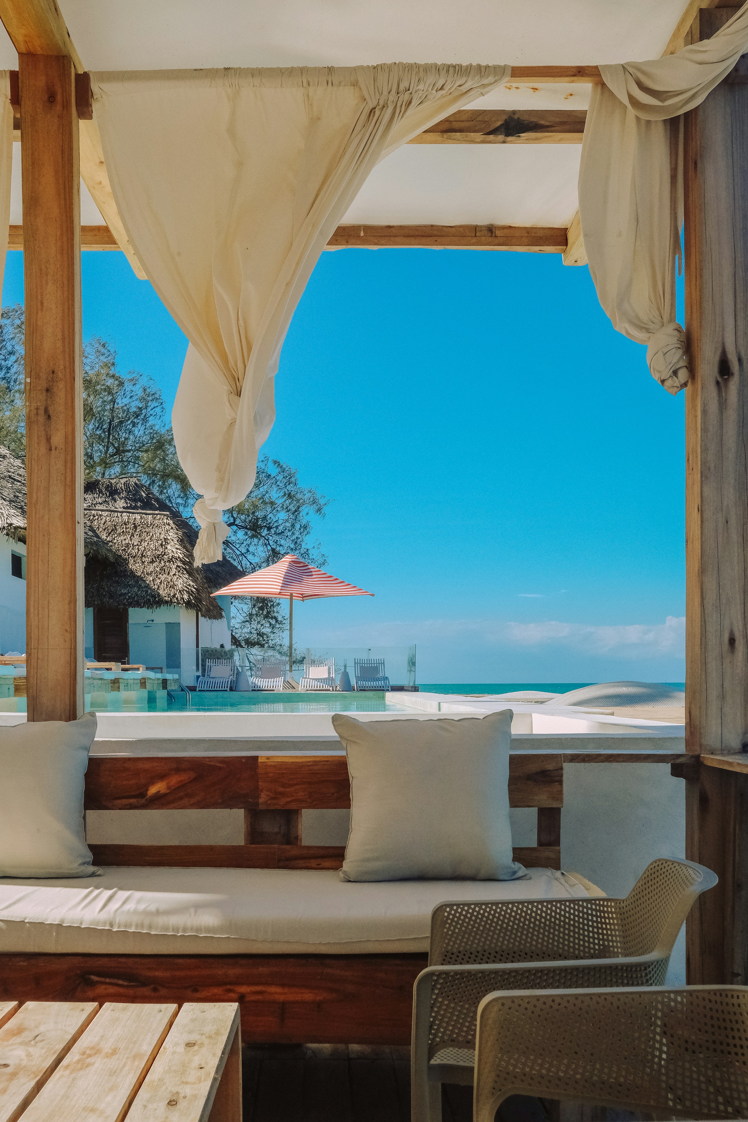 Tropical resort with beach, pool, and seating area