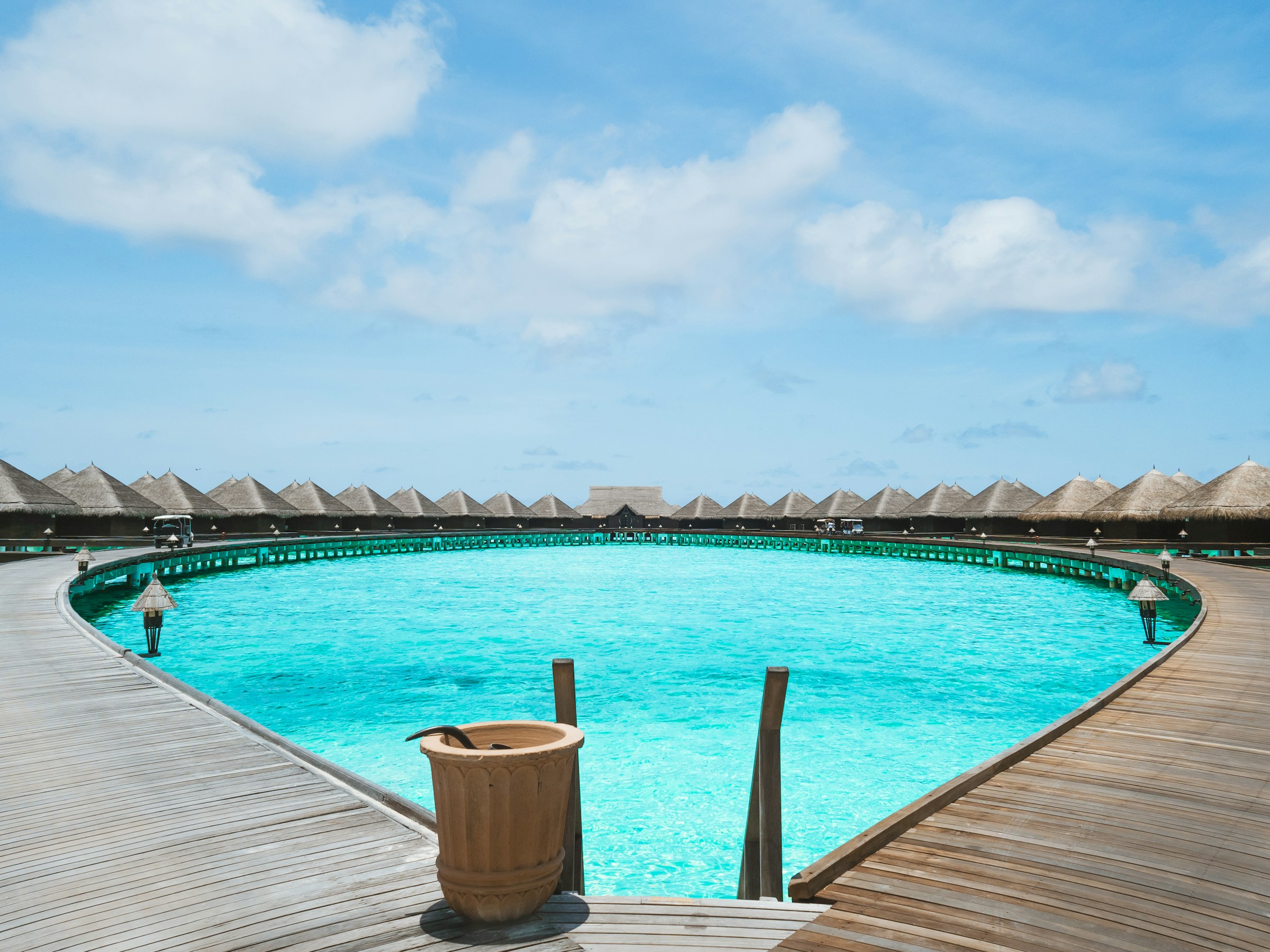 Wooden dock on blue water under a blue sky
