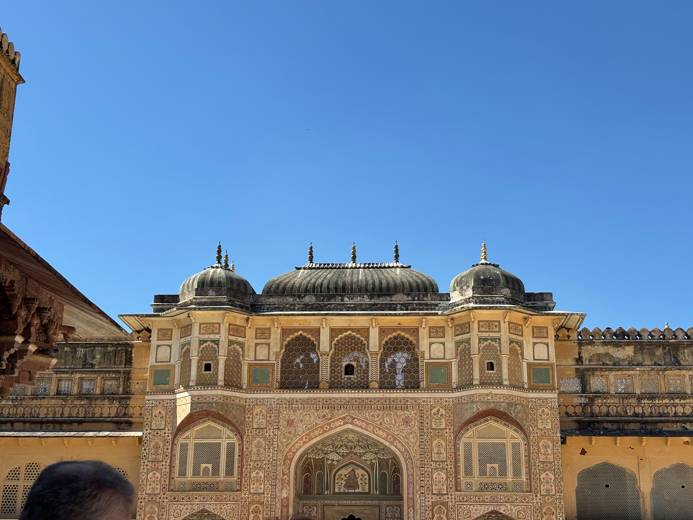 Ornate Indian palace entrance under a clear blue sky