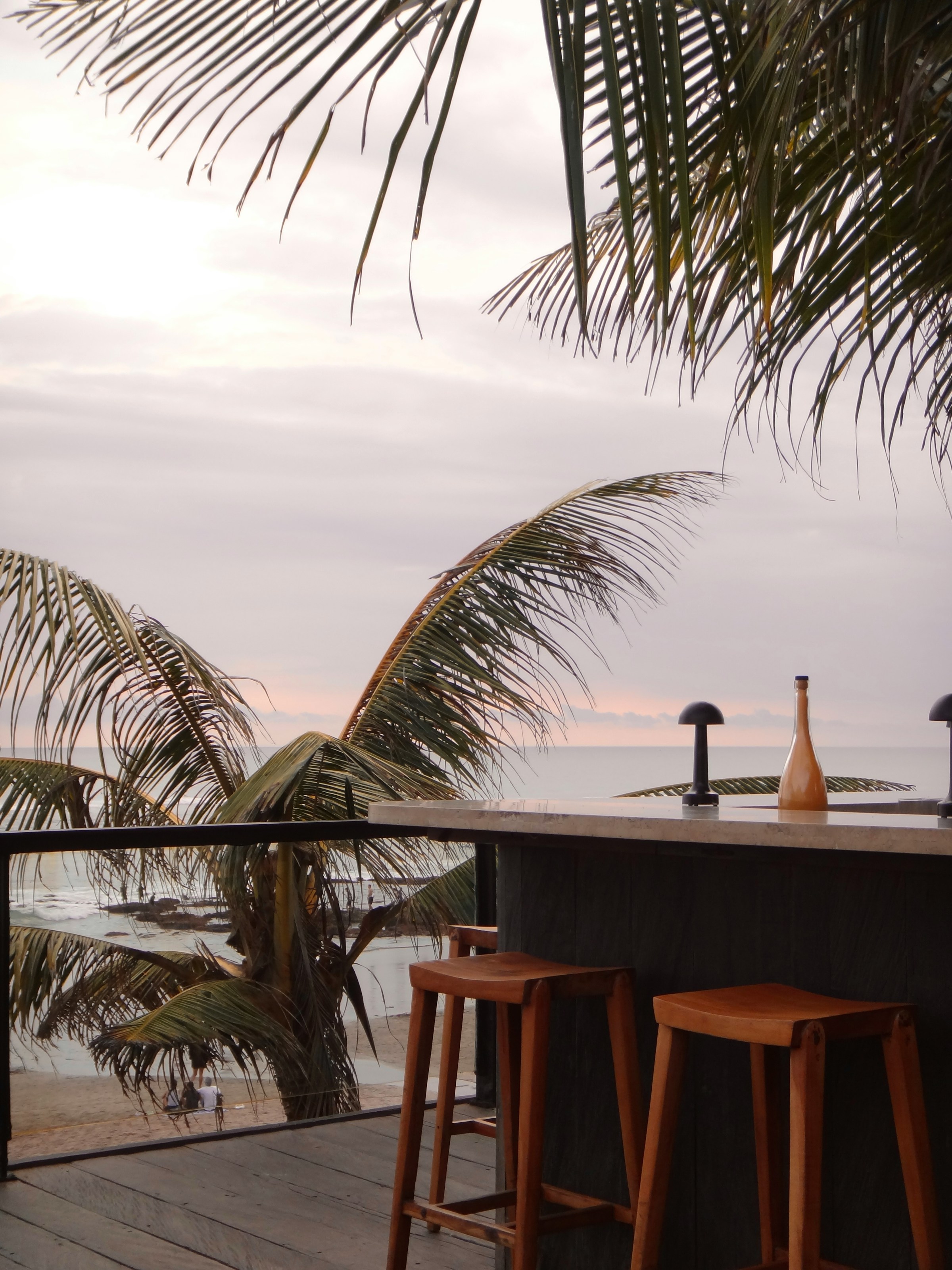 Tropical bar overlooking the ocean at sunset