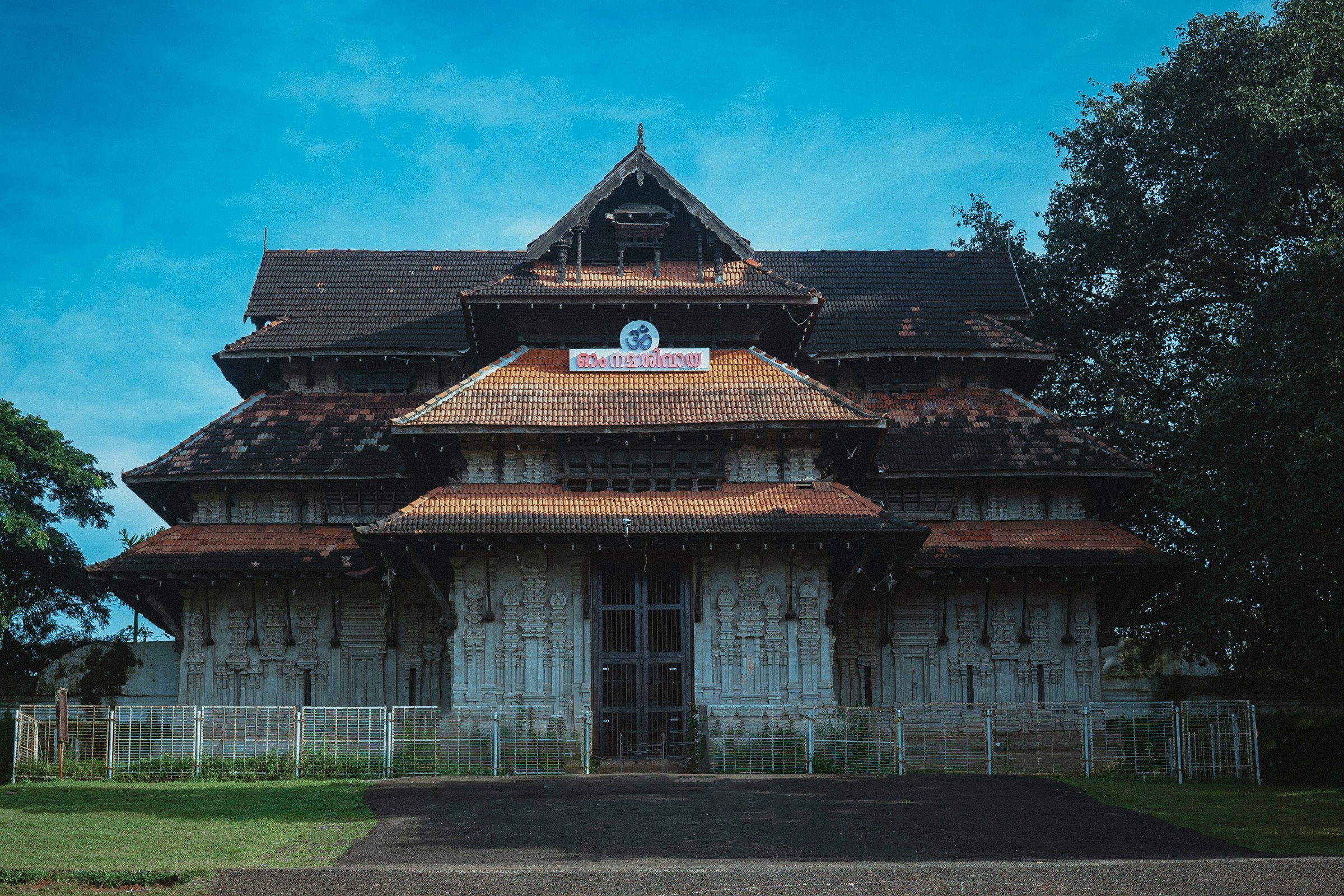 Large wooden heritage building with a fence