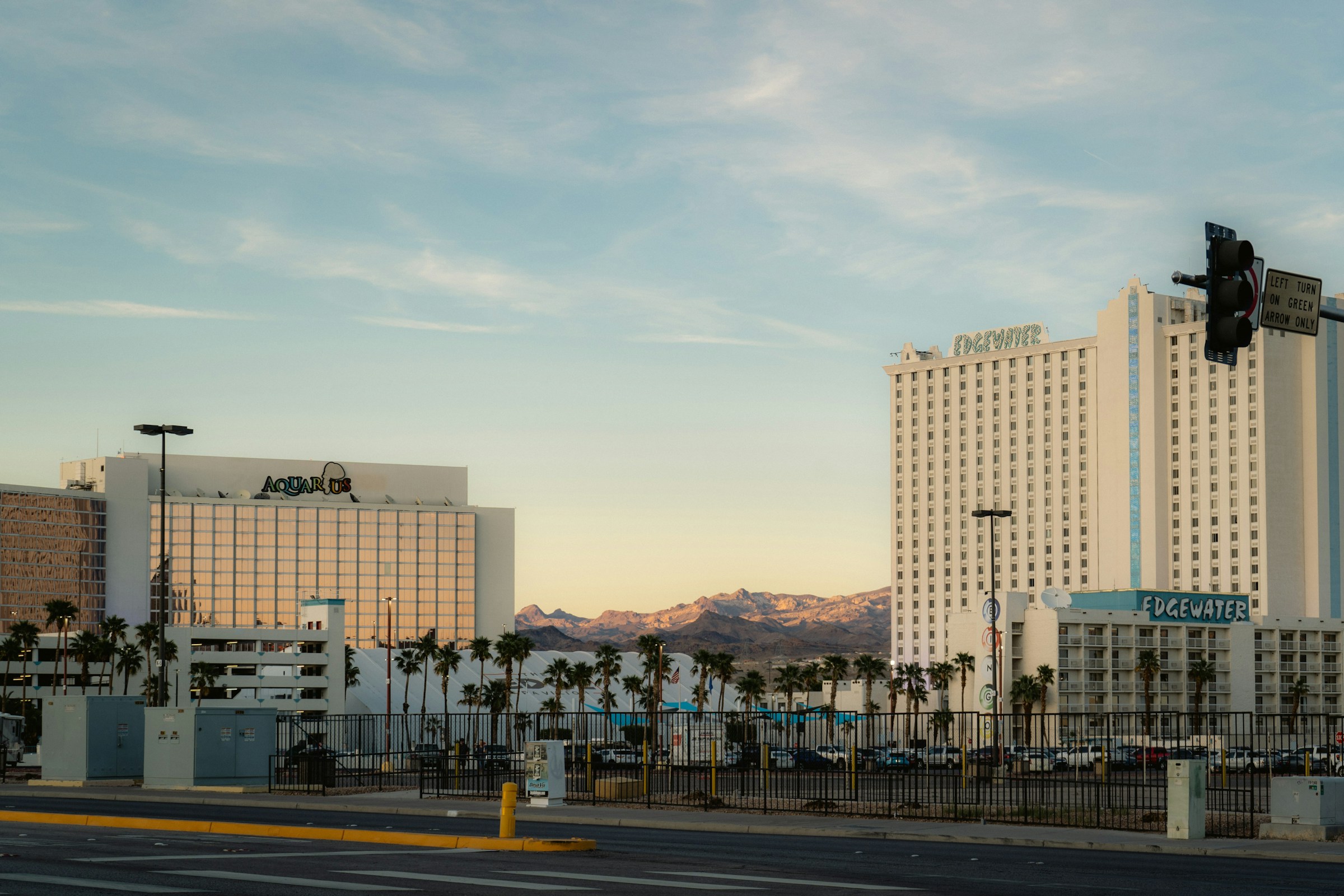 Tall hotels and palm trees at sunset