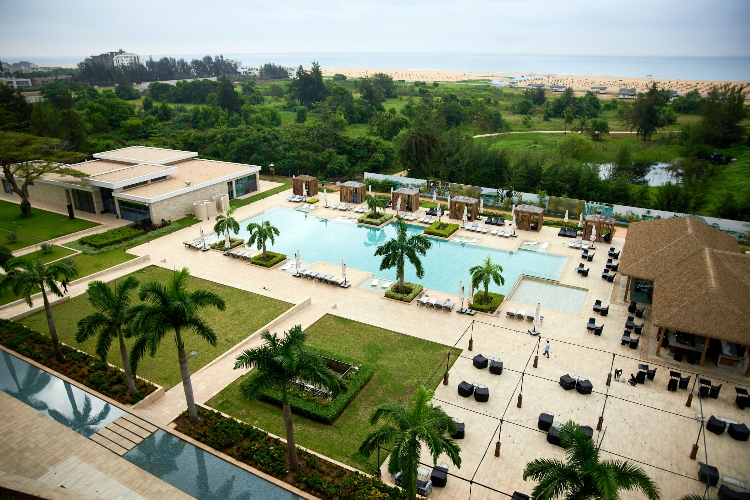 Resort complex with swimming pool and palm trees